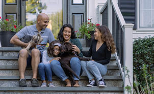 family on porch with puppy